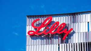 Eli Lilly (LLY) sign on a commercial building with a blue sky in the background