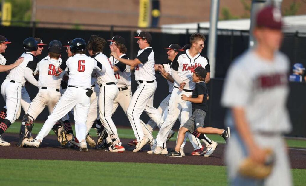 An Independence player leaves the field as Davenport Assumption celebrates their victory in the Class 3A Semi-finals of the Iowa High School State Baseball Tournament at Duane Banks Field in Iowa City on Wednesday July 20, 2022. (Cliff Jette/Freelance for the gazette)